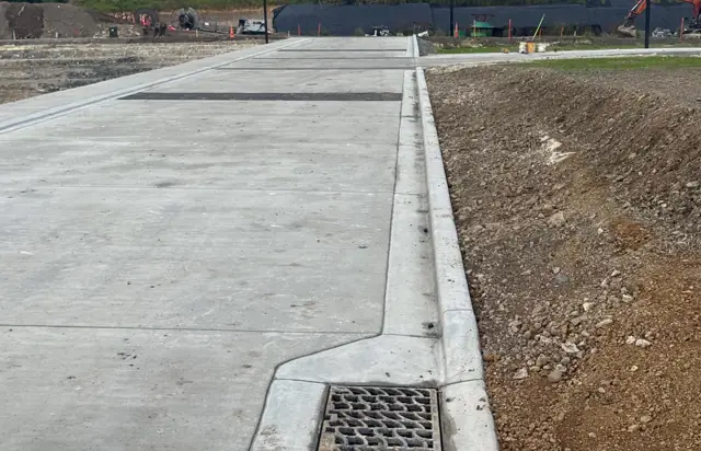 Concrete V-drain channel running beside a road
