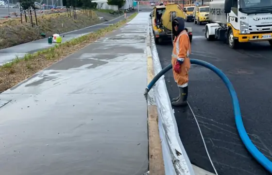 Site supervisor checking a kerb line for level